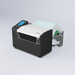 Fujifilm label printer with label rolls on a light gray background