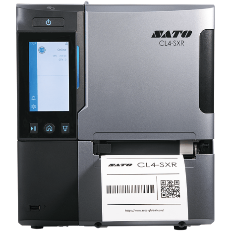 A silver and black SATO CL4-SXR industrial label printer with a front display screen and a white label being printed, shown on a plain white background.