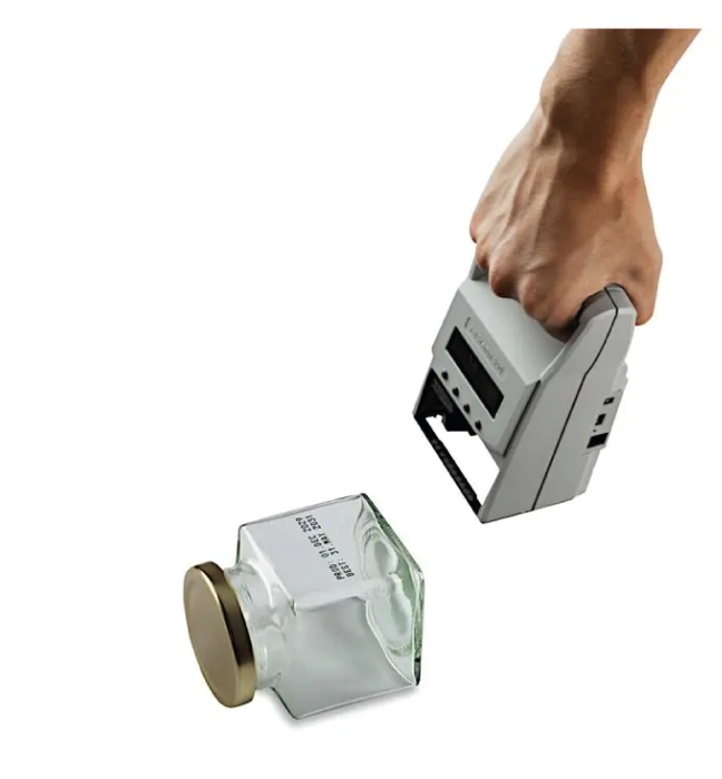 Reiner jetStamp 990, an innovative handheld inkjet printer meticulously crafted to effortlessly print text on both porous and non-porous surfaces.