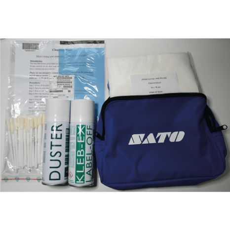SATO chemical warfare kit components laid out on a light gray background, including a blue zippered pouch with a white SATO logo, two white spray canisters labelled DUSTER and KLEB-EX LABEL-OFF, a plastic bag of cotton swabs, and a folded white cloth.