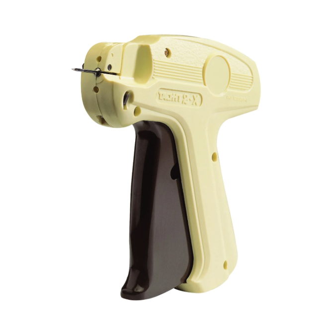 A Tach-It Fine Mk I Tagging Gun, primarily in a beige color, with a black handle and tagging needle.