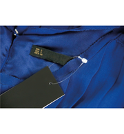 A white nylon security loop with a beaded tie, against a blue background.